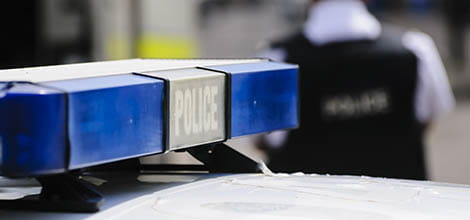 Close-up of police car and officer